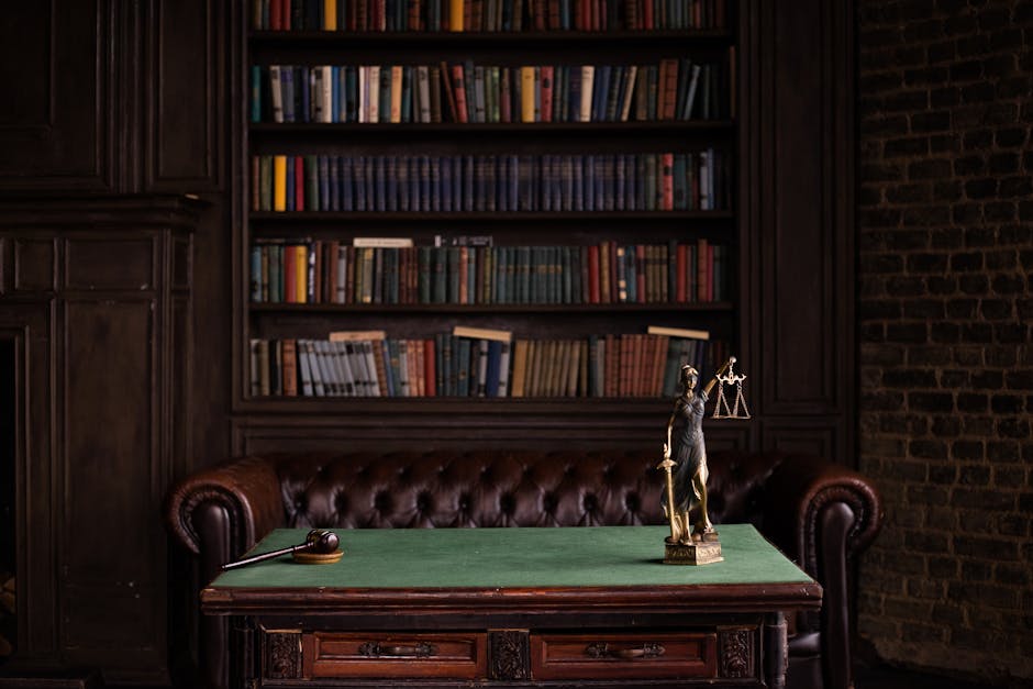 A classic study room with shelves of books, a gavel, and Lady Justice figurine