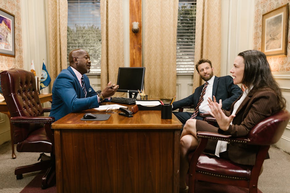 Three attorneys in a legal discussion at a well-appointed law office